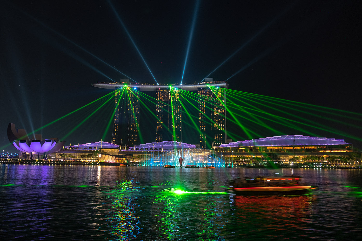 A spectacular light show plays out across the bay at night from the top of the Marina Bay Sands Hotel, Singapore. 
