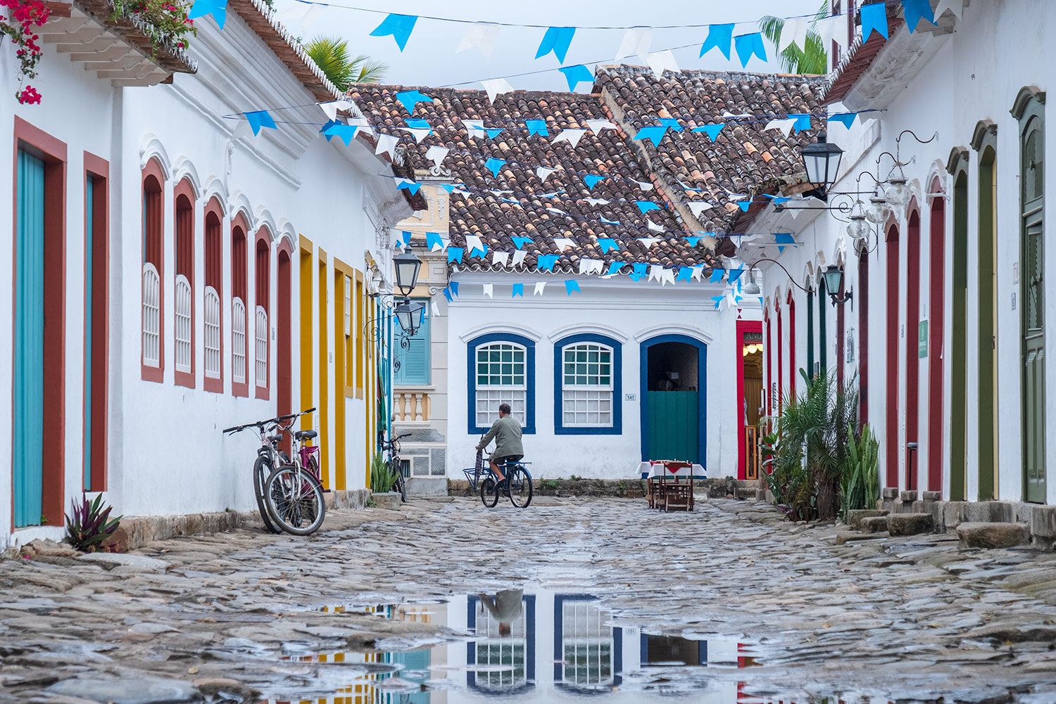 A man cycles as the floods recede in front of the brightly coloured colonial houses in Paraty, Rio de Janeiro, Brazil. 
